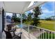 Enjoy the covered balcony with seating, offering panoramic views of the golf course and community pool at 2005 Country Club Dr, Port Orange, FL 32128
