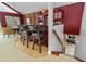 Charming home bar with seating and red cabinets leading to a game room, ideal for entertaining at 2005 Country Club Dr, Port Orange, FL 32128