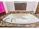 Close-up of a relaxing white jacuzzi bathtub with marble trim, offering a serene bathing experience at 2005 Country Club Dr, Port Orange, FL 32128