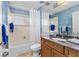 Bathroom featuring blue patterned wallpaper and wooden vanity, offering a stylish and functional space at 2005 Country Club Dr, Port Orange, FL 32128