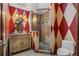 Bathroom featuring decorative wallpaper, glass shower, and vintage style vanity at 2005 Country Club Dr, Port Orange, FL 32128