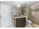 Stylish bathroom with a modern vanity, glass-enclosed shower, and a door to the exterior at 2005 Country Club Dr, Port Orange, FL 32128