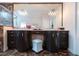 Bathroom featuring double sinks, vanity, ample mirror space, and modern lighting fixtures at 2005 Country Club Dr, Port Orange, FL 32128