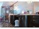 Elegant bathroom featuring a double vanity, marble floors and countertops, and a glass enclosed shower at 2005 Country Club Dr, Port Orange, FL 32128