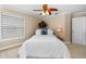 Comfortable bedroom showcasing a ceiling fan, neutral tones, and a bedside table at 2005 Country Club Dr, Port Orange, FL 32128