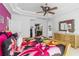 Comfortable bedroom with tray ceiling, ceiling fan, dresser, and access to the bathroom at 2005 Country Club Dr, Port Orange, FL 32128