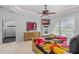 Inviting bedroom with tray ceiling, ceiling fan, television, and golf course view at 2005 Country Club Dr, Port Orange, FL 32128