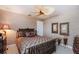 Cozy bedroom with a patterned bedspread, dresser, and a unique fan and lighting combination at 2005 Country Club Dr, Port Orange, FL 32128