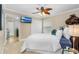 Cozy bedroom featuring a ceiling fan, neutral tones, and a large window at 2005 Country Club Dr, Port Orange, FL 32128