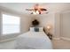 Cozy bedroom with a comfortable bed, side table, and natural light streaming through the window at 2005 Country Club Dr, Port Orange, FL 32128