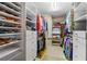 Spacious walk-in closet with built-in shelving and ample storage for clothes and shoes at 2005 Country Club Dr, Port Orange, FL 32128