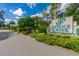 A welcome sign for Spruce Creek Fly-In Community with colorful flower beds and lush landscaping at 2005 Country Club Dr, Port Orange, FL 32128