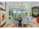 Bright dining room with modern table, comfortable chairs, and expansive views of the green landscape at 2005 Country Club Dr, Port Orange, FL 32128