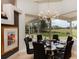 Elegant dining room with golf course view, chandelier, and seating for six at 2005 Country Club Dr, Port Orange, FL 32128