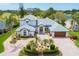 Beautiful two-story home with meticulously maintained landscaping and a circular paver driveway at 2005 Country Club Dr, Port Orange, FL 32128