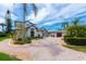 Charming two-story home with paver driveway, lush landscaping, and a grand entrance at 2005 Country Club Dr, Port Orange, FL 32128