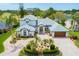 Stunning home featuring a circular driveway, lush landscaping, attached garage, and manicured lawn at 2005 Country Club Dr, Port Orange, FL 32128