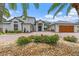 Home with brick circular driveway and lush landscaping at 2005 Country Club Dr, Port Orange, FL 32128