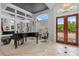Bright foyer featuring a grand piano, elegant chandelier, and double-door entry with beautiful outside views at 2005 Country Club Dr, Port Orange, FL 32128