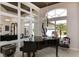 Bright foyer with a grand piano, accent lighting, and large windows offering outdoor views at 2005 Country Club Dr, Port Orange, FL 32128