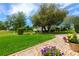 Beautifully landscaped front yard with lush green grass, decorative rocks and seasonal flowers in pots at 2005 Country Club Dr, Port Orange, FL 32128
