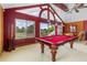Game room features a pool table, a high ceiling, and plenty of natural light; perfect for entertainment at 2005 Country Club Dr, Port Orange, FL 32128