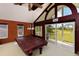 Spacious game room featuring a pool table and sliding doors to a balcony overlooking the golf course at 2005 Country Club Dr, Port Orange, FL 32128
