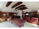 Spacious game room featuring a bar, pool table, and comfortable seating under beautiful wooden beams at 2005 Country Club Dr, Port Orange, FL 32128