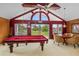 Spacious game room featuring a pool table, high ceilings, and views of the yard; perfect for recreation at 2005 Country Club Dr, Port Orange, FL 32128