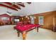 A game room features a pool table, seating, and a television; perfect for leisure and entertainment at 2005 Country Club Dr, Port Orange, FL 32128
