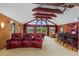 Spacious game room featuring red leather seats, a bar, and a pool table perfect for hosting guests at 2005 Country Club Dr, Port Orange, FL 32128