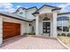 Luxurious home exterior with a three-car garage and brick driveway at 2005 Country Club Dr, Port Orange, FL 32128