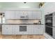 Elegant kitchen featuring sleek white cabinetry, modern appliances, and stylish backsplash at 2005 Country Club Dr, Port Orange, FL 32128