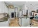Spacious kitchen with stone countertops, modern appliances, and tile flooring leading into the dining area at 2005 Country Club Dr, Port Orange, FL 32128