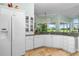 Bright kitchen features white cabinets, granite countertops, stainless steel appliances and large window at 2005 Country Club Dr, Port Orange, FL 32128