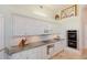 Updated kitchen boasting white cabinets, stone countertops, stainless appliances, and an open, airy feel at 2005 Country Club Dr, Port Orange, FL 32128
