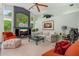 Airy living room featuring vaulted ceilings, large windows, comfortable seating, and a large TV at 2005 Country Club Dr, Port Orange, FL 32128