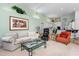 Open concept living room with integrated kitchen, light walls, and comfortable seating arrangements at 2005 Country Club Dr, Port Orange, FL 32128
