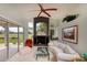 Spacious living room featuring large windows with golf course views, comfortable seating, and modern décor at 2005 Country Club Dr, Port Orange, FL 32128