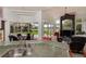 Open concept living and dining area with golf course views and an accent fireplace at 2005 Country Club Dr, Port Orange, FL 32128