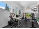 Bright home office with large windows, neutral decor, and workspace to exterior patio at 2005 Country Club Dr, Port Orange, FL 32128