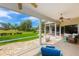 Serene screened-in patio offers beautiful golf course views and tranquil outdoor living space at 2005 Country Club Dr, Port Orange, FL 32128