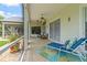 Screened patio with chaise lounge and decorative accents, creating a relaxing outdoor space at 2005 Country Club Dr, Port Orange, FL 32128