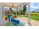 Inviting screened-in patio with comfortable lounge chair, grill, and scenic golf course backdrop at 2005 Country Club Dr, Port Orange, FL 32128