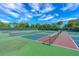 Exterior view of well-maintained, multi-colored tennis and pickleball courts at 2005 Country Club Dr, Port Orange, FL 32128