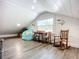 Finished attic with a window, wooden floor, bean bag chair, table and a rocking chair at 216 Murray St, New Smyrna Beach, FL 32168