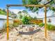 Secluded backyard with fire pit, hammock, and lush greenery offers a perfect relaxation spot at 216 Murray St, New Smyrna Beach, FL 32168