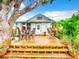 Expansive deck provides multiple seating areas for outdoor entertaining, surrounded by tropical landscaping at 216 Murray St, New Smyrna Beach, FL 32168