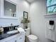 This bathroom features granite counters, sleek fixtures, and a crisp, bright aesthetic at 216 Murray St, New Smyrna Beach, FL 32168