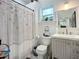Stylish bathroom features a shower, vanity, and a window that adds natural light to the space at 216 Murray St, New Smyrna Beach, FL 32168